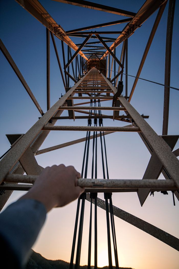 Dramatic angle of a steel tower against the evening sky highlighting industrial architecture.